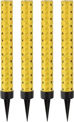 Four golden birthday candles with black star patterns are arranged in a row against a white background.