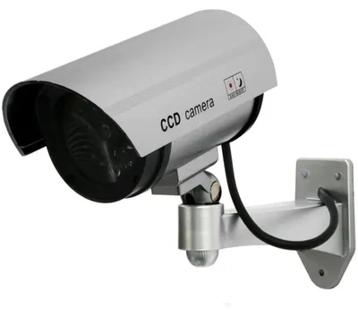 Zdjęcie produktu dla Kamera atrapa zewnętrzna ścienna z migającą diodą LED IR srebrna monitoring atrapa kamery z kołkami