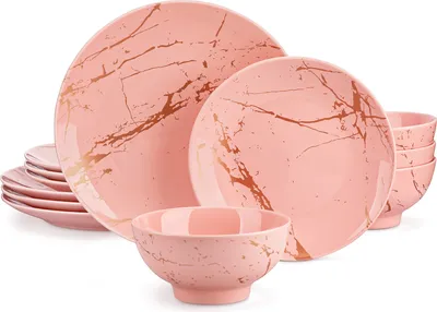 A set of pink porcelain dishes with a gold marble pattern.