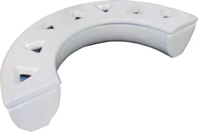 A white ceramic room humidifier shaped like a crescent moon with triangular cutouts.