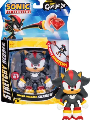 The image shows the packaging of a Heroes of Goo Jit Zu Sonic the Hedgehog Chaos Emerald SHADOW Stretchy Hero toy. The packaging is colorful and features graphics of the character. A smaller, out-of-package figure is also shown next to the packaging.