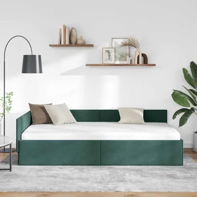 A dark green daybed with a white mattress and pillows is shown in a minimalist room setting with shelves on the wall.