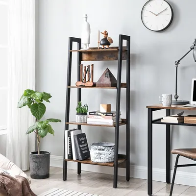 A ladder shelf filled with decorative items and books, placed next to a desk with a laptop and lamp.