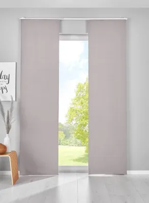 Two gray panel curtains are shown hanging in front of a window with a view of trees and grass.