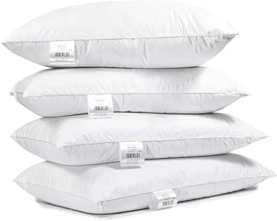 A stack of four white pillows against a white background.
