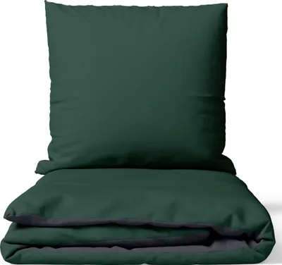 A folded duvet cover and a pillow are stacked on top of each other against a white background.