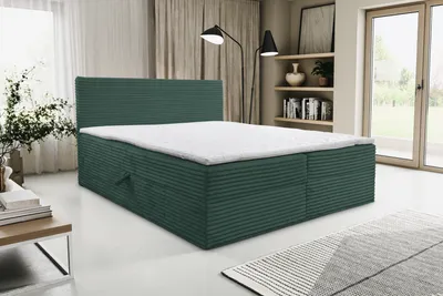 A green boxspring bed with a white mattress is shown in a room with curtains and a window.