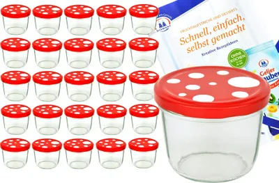 A collection of small glass jars with red and white mushroom-shaped lids, arranged in rows, with a larger jar in the foreground and some packaging in the background.