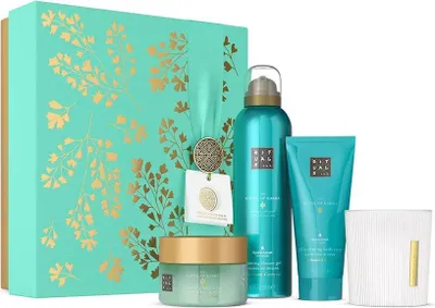 A gift set of Rituals Karma products, including a box, body cream, shower foam, and candle.