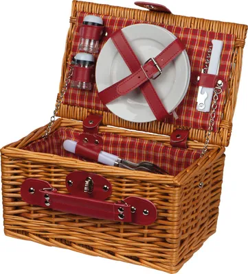 An open wicker picnic basket with red plaid lining and red leather accents, filled with picnic essentials.
