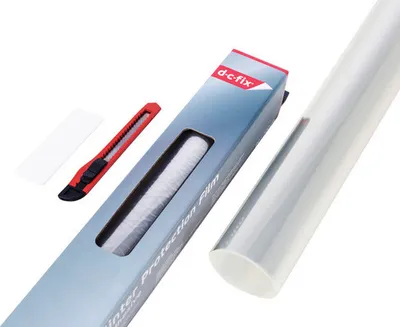 A roll of clear protection film and a box containing a utility knife and a small white sheet are arranged on a white background.
