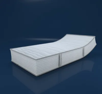 A white mattress with gray trim is shown on a dark blue reflective surface.