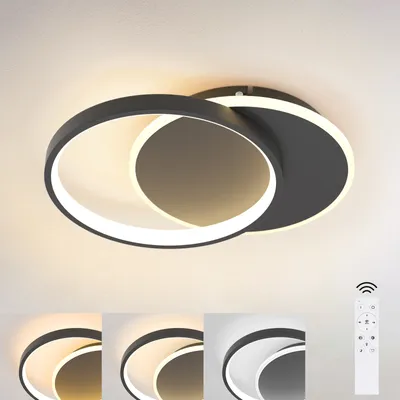 A modern LED ceiling light with two interlocking rings, shown against a white ceiling. Below the main product image are four smaller images demonstrating different light color temperatures, and a remote control.