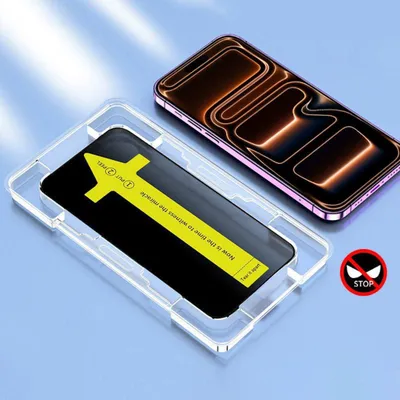 A screen protector being applied to a smartphone using an installation guide.