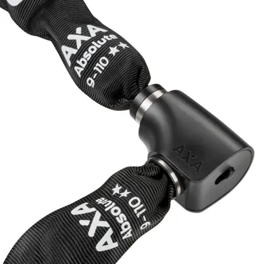 A close-up of a black bicycle chain lock with silver metal accents.