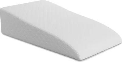 A white wedge pillow on a white background.