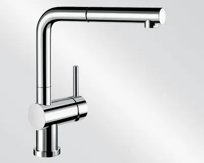 A studio shot of a chrome kitchen faucet against a gradient background.