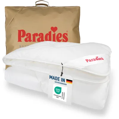 A folded white duvet is shown in front of its brown packaging bag, both featuring the brand logo.