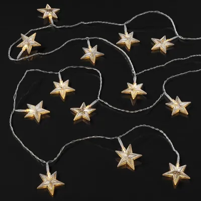A string of LED lights shaped like stars on a black background.