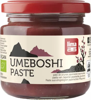 A jar of Umeboshi paste with a label featuring mountains and a tree.