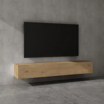 A modern wall-mounted TV stand with a black television above it, set against a concrete wall.