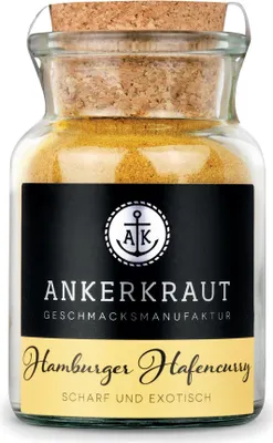 A glass jar of curry spice with a cork stopper, labeled with brand and product information.