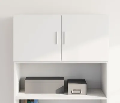 A white wall-mounted cabinet with two doors, and two storage boxes on the shelf below.
