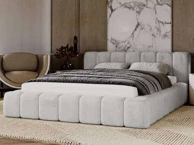 A modern bedroom setting with a light gray upholstered bed as the focal point.