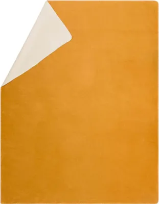 A folded blanket with one side gold and the other side cream.