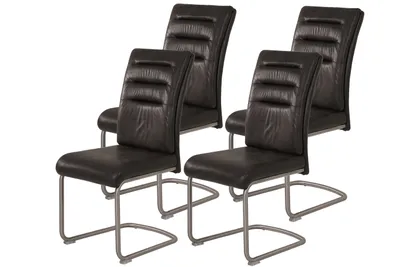 Four dark gray cantilever dining chairs with metal frames and leather seats and backs.