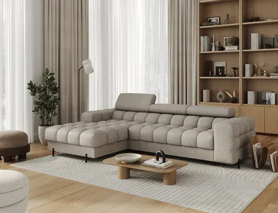 A modern living room with a sectional sofa, coffee table, and bookshelf.