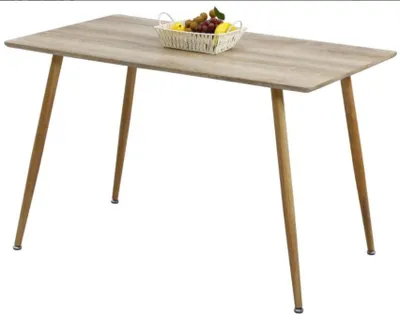A wooden dining table with a basket of fruit on it.