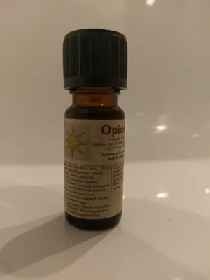 Kleine braune Flasche mit einem schwarzen Verschluss. Auf dem Etikett steht "Opium".