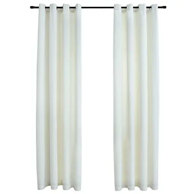 Two cream-colored curtains hanging from a black curtain rod against a white background.