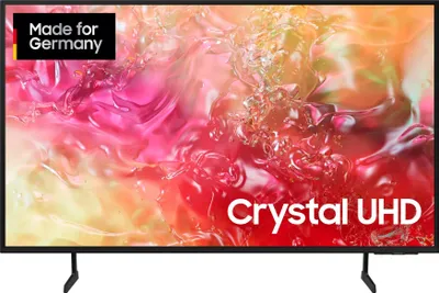 A Samsung Crystal UHD 4K TV is displayed on a stand against a black background. The screen shows a colorful, abstract image with text overlays.