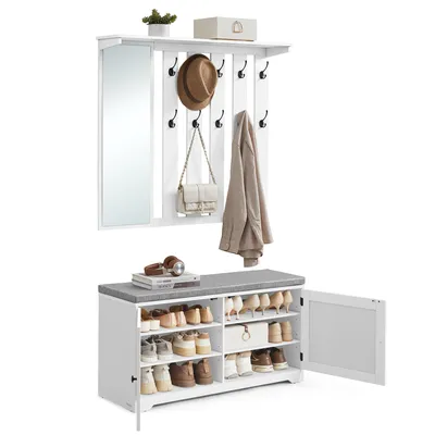 A white hall tree with a mirror and coat hooks, and a white shoe bench with a gray upholstered top, set against a white background.