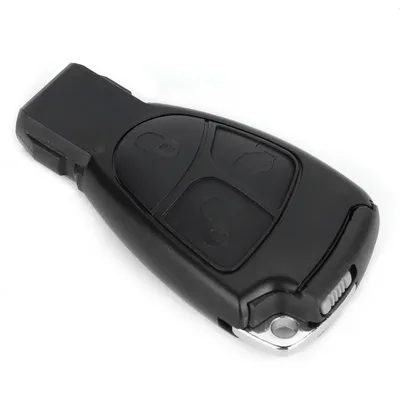 A black car key fob with three buttons and a silver metal loop on a white background.