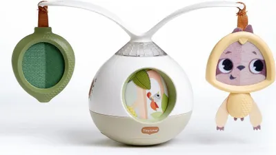 A baby mobile with a central unit and two hanging toys, displayed against a white background.