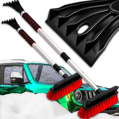 A car covered in snow with snow removal tools.