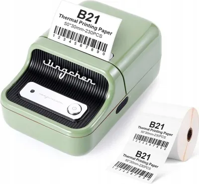 A green label printer with a roll of labels next to it.