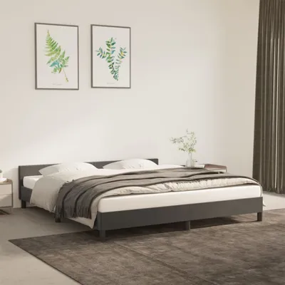 A bedroom scene with a dark gray bed frame, white bedding, and a gray blanket.