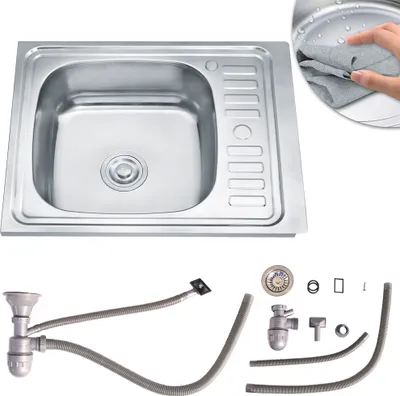 A stainless steel kitchen sink and its plumbing accessories are displayed against a white background.