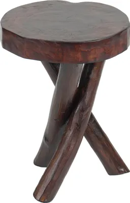 A dark brown, solid wood side table with a round, irregular top and three crossed legs.