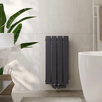 A modern bathroom with a radiator, bathtub, and plant.