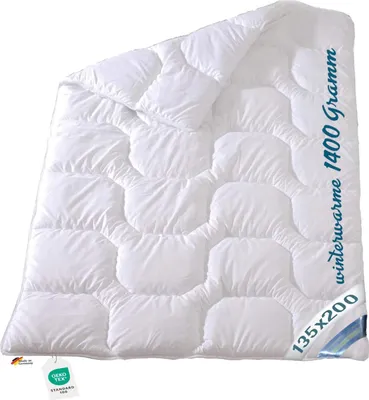 A white duvet folded and laid out on a white background.