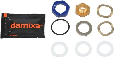 A collection of plumbing parts and a packet of lubricant, laid out on a white background.