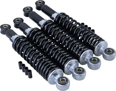 Four black shock absorbers with silver ends are arranged diagonally on a white background.
