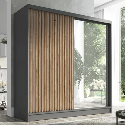 A modern wardrobe with a combination of wood-look slats and a mirrored door, set against a neutral background with hints of an indoor environment.