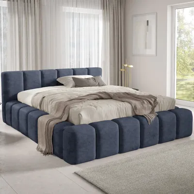 A bedroom with a large upholstered bed.