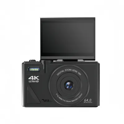 A black digital camera with its screen flipped up, shown against a white background.